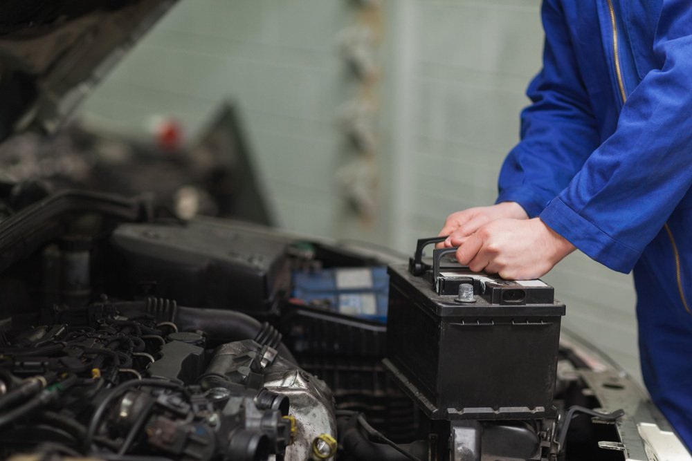 Mechanic removing parts from a vehicle